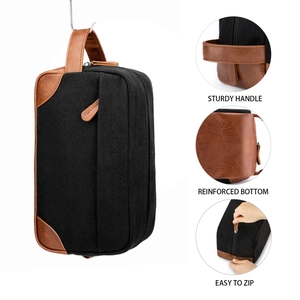 Close-up details of men's canvas and leather toiletry bag showing handle and zipper