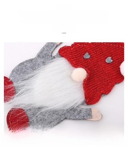 Detail of Christmas gnome cutlery holder showing red knitted hat and white plush beard