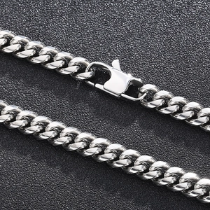 Macro shot of silver stainless steel Cuban link chain with a secure lobster clasp