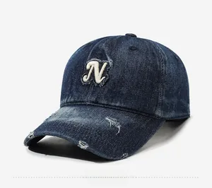 Close-up of distressed denim baseball cap with white towel embroidered N letter logo