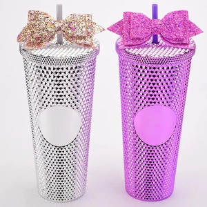 Detail of glitter bow accessories on studded tumblers in silver and pink colors