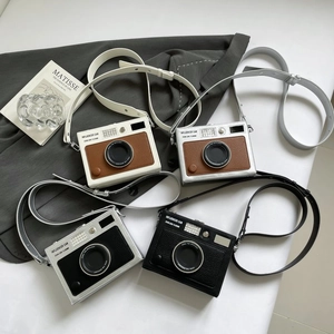 Vintage camera-shaped crossbody bag in various colors with retro lens detail