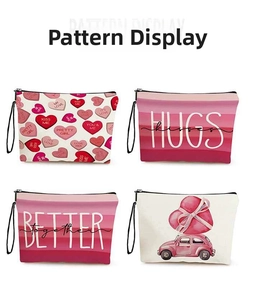 Detail view of four pink makeup bags with heart patterns and black wristlet straps