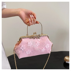 Detail of pink floral evening bag with lace embroidery and sparkling crystal clasp