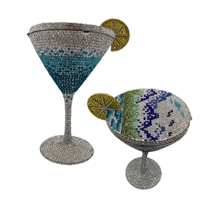 Detailed view of cocktail glass clutch bags with sparkling crystals and lemon slice detail