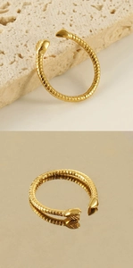 Macro detail of gold-plated stainless steel spiral ring with textured ribbed finish
