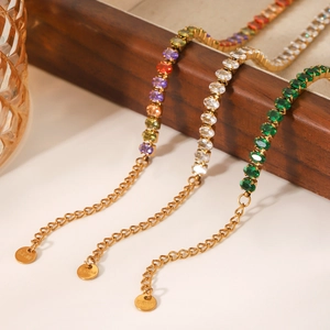Elegant gold-plated stainless steel bracelets set with colorful zircon on wooden tray