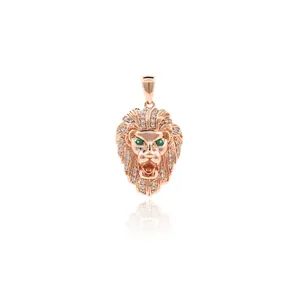 Detail of lion head pendant in rose gold with green gemstone eyes and micro-pave crystals