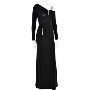 Detail of rhinestone embellishments on a black one-shoulder evening gown with long sleeves