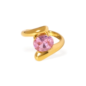 Irregular gold stainless steel ring with a pink oval zircon stone on white background