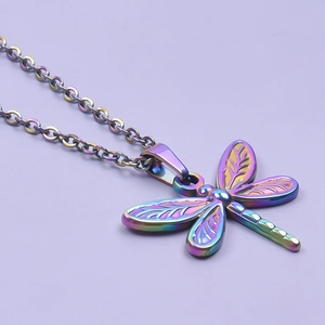 Macro view of a colorful dragonfly pendant necklace with vibrant rainbow plating