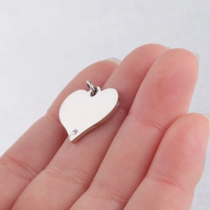 Macro shot of silver stainless steel heart pendant with sparkling inset crystal