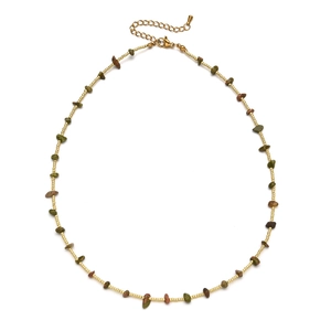 Detail of colorful irregular natural stones and golden beads on a handmade boho necklace