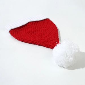 Detailed close-up of the red knit Christmas hat showing ribbed white brim and soft texture