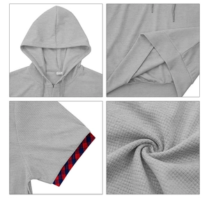Detail view of gray waffle knit hoodie with red and blue plaid lining on short sleeves