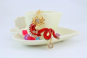 Detailed view of golden dragon keychain with red enamel and sparkling rhinestones