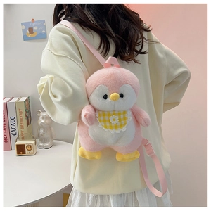 Pink plush penguin backpack with daisy bib and adjustable straps worn by a model