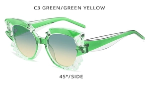 Detail of green translucent irregular sunglasses with faceted frames and gradient lenses