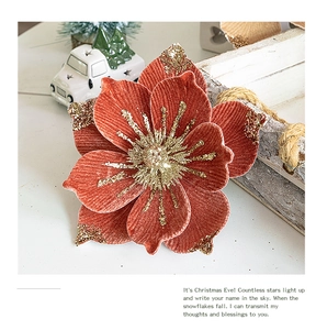 Macro detail of velvet Christmas flower with gold glitter edges for tree decoration