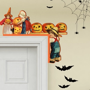 Detail of vintage Halloween door corner decor featuring kids and pumpkins on a white frame