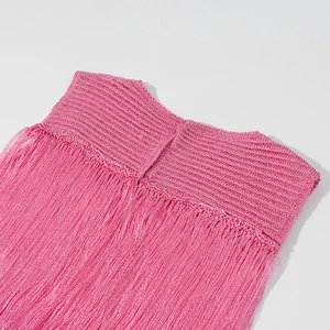 Detail of fuchsia ribbed knit fabric and hanging fringe tassels for women's dress