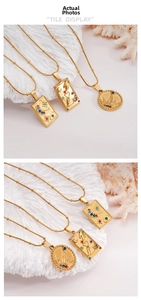 Detailed close-up of tarot moon and sun pendants on gold beaded stainless steel chains
