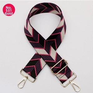 Close-up of woven bag strap with geometric V-pattern and gold metal swivel hooks