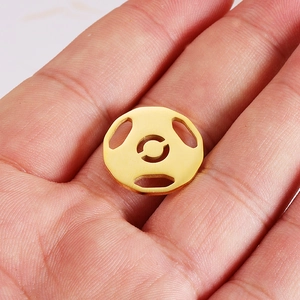 Polished gold hollow soccer pendant made of stainless steel displayed in hand