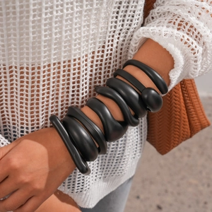Dark style matte black acrylic spiral bangle featuring minimalist irregular geometry