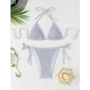 Detail of light blue floral bikini set with smocking texture and side tie bottom