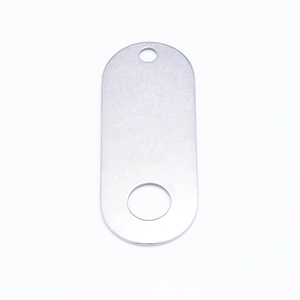 Detailed macro view of an oval brushed silver metal tag with two functional connection holes