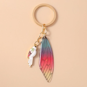 Detailed view of luxury parrot keychain with enamel bird and gradient resin wing charms