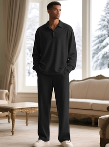 Detail of men's black long-sleeve polo lounge set with diamond knit texture in indoor setting