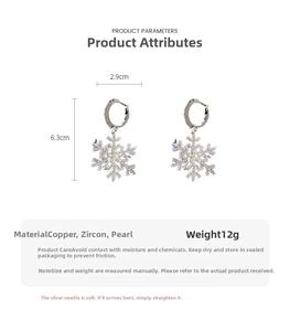 Detailed view of rhinestone snowflake earrings showing 6.3cm height and 2.9cm width