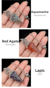 Detail of tree of life charm and hexagonal resin crystal pendulum with metal wire wrap