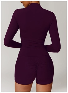 Rear view of tight purple yoga set showing ruched booty lifting shorts and long sleeve top