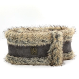 Macro shot of faux suede ear warmer with fluffy artificial fur trim and leather logo tag