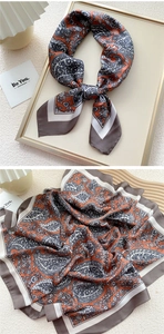 Detail of paisley print silk scarf with vintage orange and charcoal grey patterns
