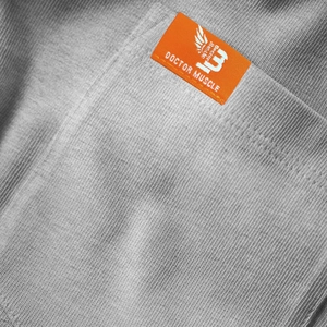 Close-up of grey knitted fabric texture with a premium orange brand woven label