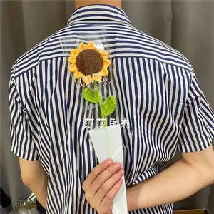 Detail of hand-knitted crochet sunflower bouquet in LOVE transparent gift packaging