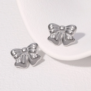 Minimalist silver bow knot earrings in polished stainless steel for women