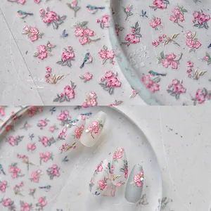Detailed macro view of 5D embossed nail stickers with Chinese style flower and bird patterns