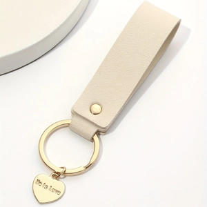 Minimalist beige leather heart keychain with life is love gold engraved heart charm