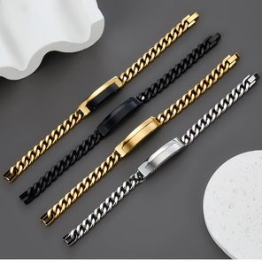 Detail view of Cuban link bracelets in gold, black, and silver with metal plates