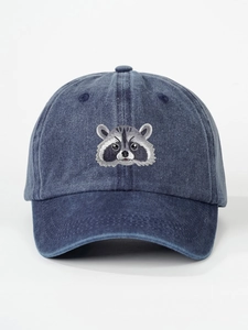 Detailed view of the washed denim raccoon embroidery on a dark blue retro baseball cap