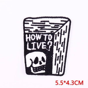 Macro shot of skull and 'How to Live?' embroidery patch showing stitches and size 5.5x4.3cm