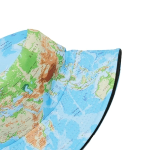 Detail showing world map print on blue bucket hat fabric with fine stitching