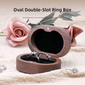Detailed view of oval black walnut wood double slot ring box with magnetic closure