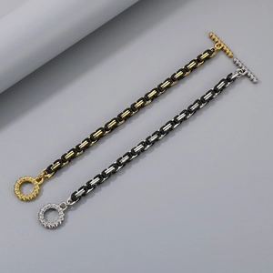 Detail of stainless steel king chain bracelet with skull OT buckle in gold and silver