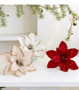 Detail of glittered velvet poinsettia flowers with pearl stamens for Christmas decor